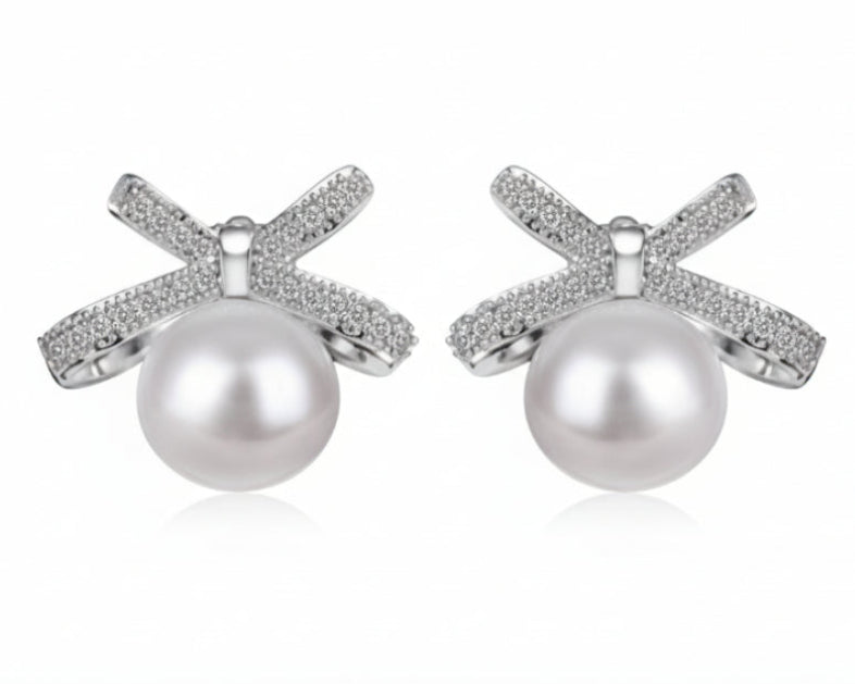 Pearl earrings with silver X-shaped designs on a white background
